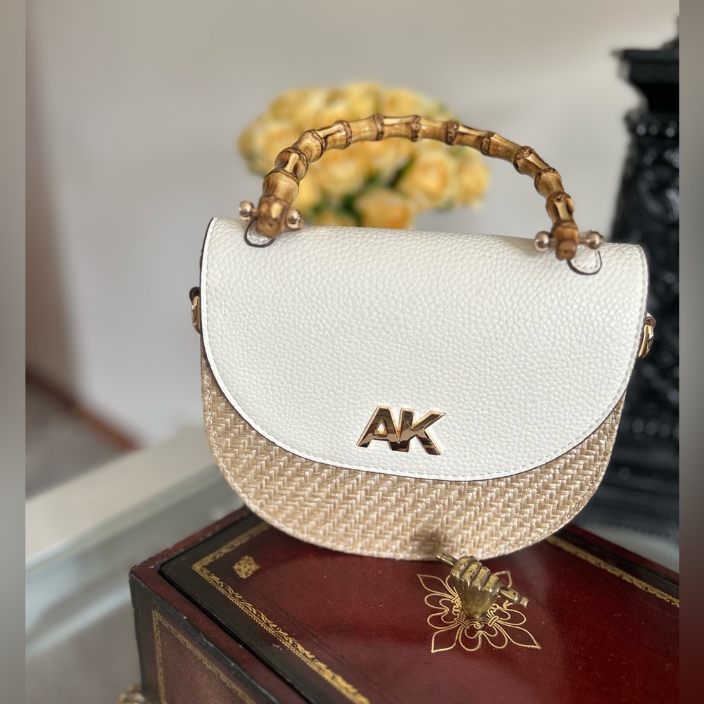 Preowned used once.  Anne Klein mini bamboo top bamboo bag.